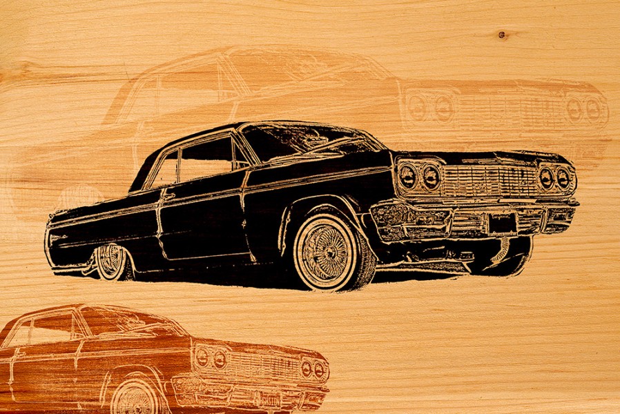 Photo illustration of 1964 Impala lowrider on wood
