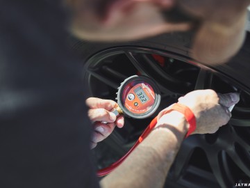 Driver Ed Sporbert checking tire pressure between sessions. Sonoma Raceway | Apex Wheels